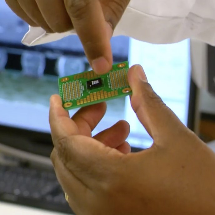 Close up of hands holding a digital chip.