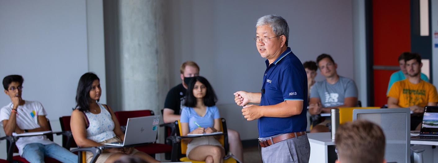 An instructor lectures students in a flexible classroom area.