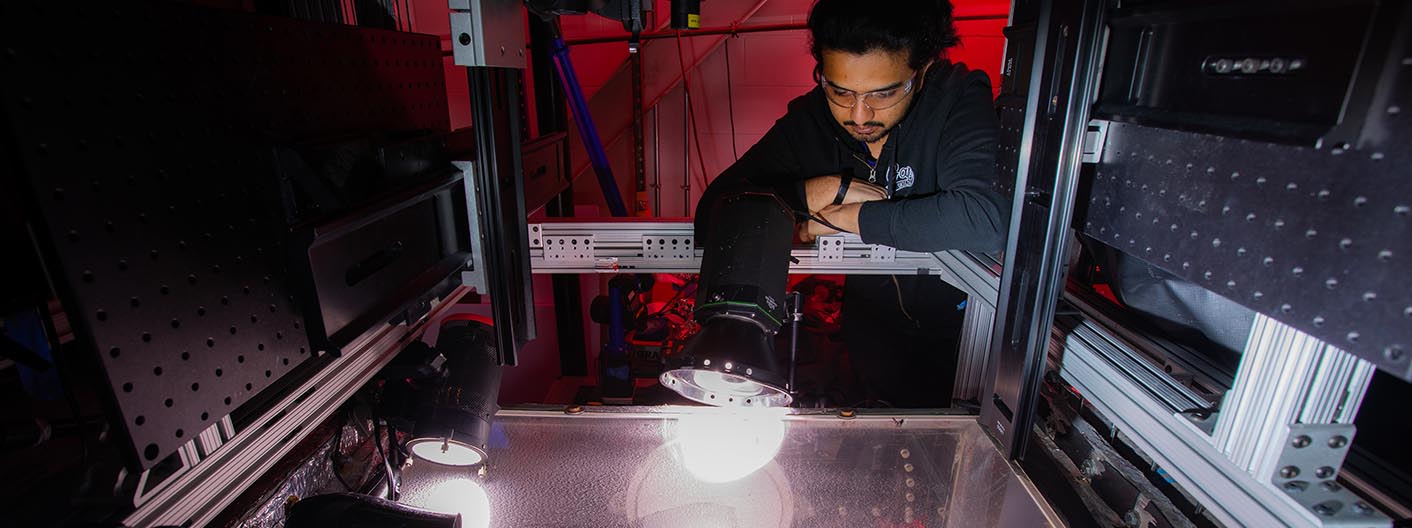 PhD student Harsha Sista surveys the Icing Research Tunnel inside Howe Hall, as freezing moisture moves through the tunnel, attaching to a wing section.