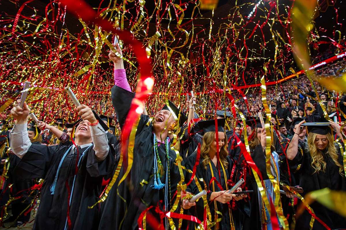Graduates celebrate with streamers at the conclusion of the ceremony.